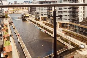 a view of a river in a city with buildings at Deluxe River Canal View & Free Secure Parking! in Leeds