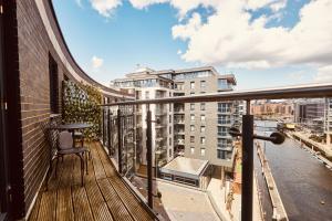 a balcony with a table and a view of a city at Deluxe River Canal View & Free Secure Parking! in Leeds