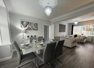 comedor y sala de estar con mesa y sillas en Modern 3-bed stay-away-home sleeps 6 nr Manchester, en Mánchester