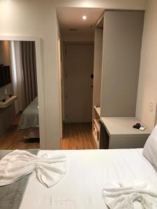 Un pat sau paturi într-o cameră la Apart-hotel TrueAmérica