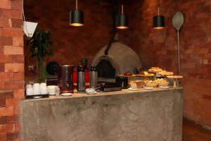 a table with food on top of it with an oven at Nobile Hotel Belo Horizonte in Belo Horizonte