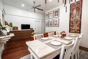 a kitchen and dining room with a table and chairs at The Color Kata in Kata Beach