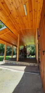 a large wooden pavilion with a wooden ceiling at Apartamenty u Rudej in Olszanica