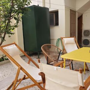 a group of chairs and a table and a green cabinet at HOME away from home_3BR at Maniatika_14min walk to the port in Piraeus