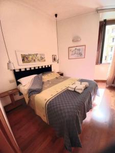 a bedroom with a large bed with two towels on it at la casa del viaggiante in Rome