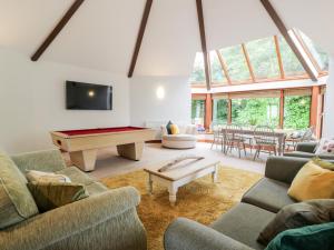 a living room with couches and a pool table at Shieldhill Farm House in Falkirk