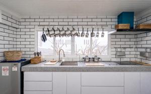 a kitchen with a sink and a window at The Color Kata in Kata Beach