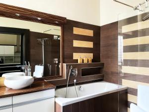 a bathroom with two sinks and a large mirror at Deluxe Cosmopolitan Apartment Budapest, with Private Parking by NeWave Apartments in Budapest