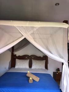 a stuffed animal is sitting on top of a bed at Tira Amed Homestay in Amed