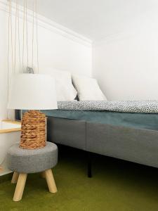 een slaapkamer met een bed met een stoel en een lamp bij Deluxe Cosmopolitan Apartment Budapest, with Private Parking in Boedapest