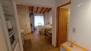 a room with a bedroom and a bed in a room at ANIDO Cabañas y Monoambientes in Lago Puelo