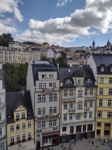 a group of buildings in front of a city at Apartmán Uvalská in Karlovy Vary