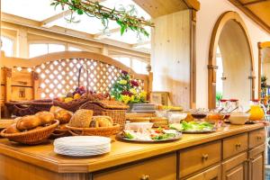 a table with bread and baskets of food on it at Hotel und Restaurant Piccolo in Thale