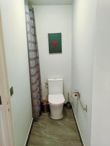 een badkamer met een toilet en een foto aan de muur bij Paris La Defense - Courbevoie vue sur Seine in Courbevoie