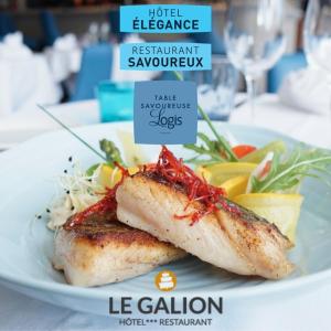 zwei Stücke Fisch auf einer weißen Platte mit Nahrung in der Unterkunft Le Galion Hotel et Restaurant Canet Plage - Logis in Canet-en-Roussillon