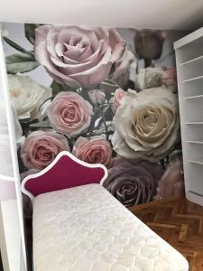 a bedroom with a flower mural on the wall at Milošević in Šabac