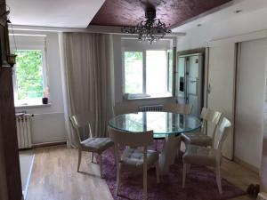 a dining room with a glass table and chairs at Milošević in Šabac