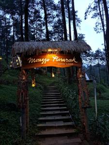 a entrance to a massage temple with a grass roof at Locca Lodge in Mojokerto