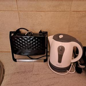 a toaster and a coffee maker sitting on a counter at Riga Fereou apartments in Patra