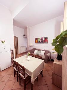 a living room with a table and a couch at Butera Apartments in Bagheria