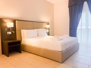A bed or beds in a room at Brain Apartment Pagani