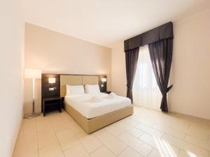 A bed or beds in a room at Brain Apartment Pagani