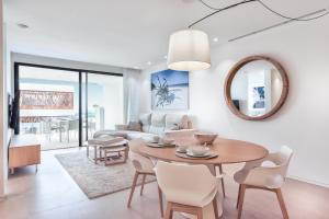 a living room with a table and chairs at Infinity 0-2 LUXE PARTIAL SEA VIEW 2B in Arona