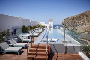 a swimming pool with lounge chairs on a building at Infinity 0-2 LUXE PARTIAL SEA VIEW 2B in Arona