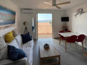 una sala de estar con un sofá y una mesa en Loft T3 Duplex Vue Mer Porquerolles, en Hyères