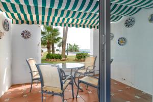 a patio with a table and chairs under awning at Playa Lucera in Sitio de Calahonda +13 photos