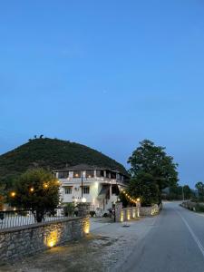 a large building with lights on the side of a road at Hotel Aroma in Përmet