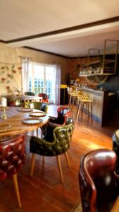a living room with chairs and a table and a dining room at Villa Westfalia Boutique Villa & SPA Adult Only` in Târgu Secuiesc