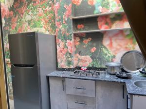 a kitchen with a refrigerator and a counter top at Trio Villa with coverable private pool in compound near Mall of Egypt in Sheikh Zayed