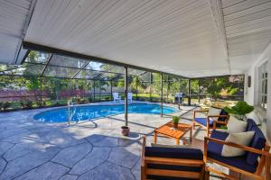 a swimming pool with a pergola and a patio at Lazy Manatee Pool Home in Bradenton