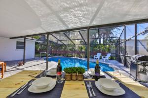 a dining table with two bottles of wine on it at Lazy Manatee Pool Home in Bradenton