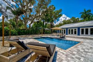 ブレーデントンにあるSerenity Of The Seaの椅子と家のあるプール