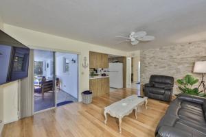 a living room with a couch and a table at Lazy Manatee Pool Home in Bradenton