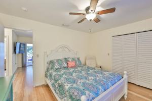 a bedroom with a bed and a ceiling fan at Lazy Manatee Pool Home in Bradenton