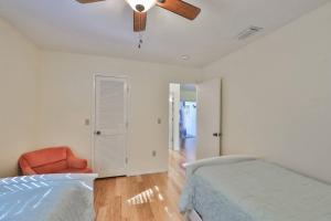 a bedroom with a bed and a ceiling fan at Lazy Manatee Pool Home in Bradenton