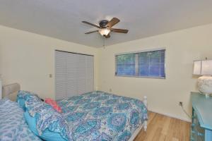a bedroom with a bed and a ceiling fan at Lazy Manatee Pool Home in Bradenton