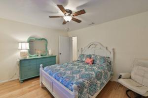a bedroom with a bed and a ceiling fan at Lazy Manatee Pool Home in Bradenton