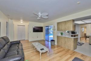 a living room with a couch and a table at Lazy Manatee Pool Home in Bradenton