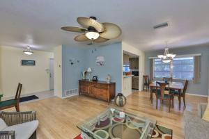 a living room with a table and a dining room at Lazy Manatee Pool Home in Bradenton