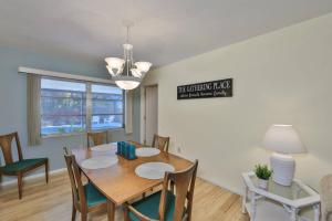 a dining room with a wooden table and chairs at Lazy Manatee Pool Home in Bradenton