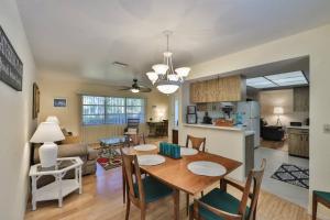 a dining room and living room with a table and chairs at Lazy Manatee Pool Home in Bradenton