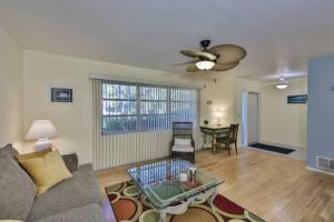 a living room with a couch and a ceiling fan at Lazy Manatee Pool Home in Bradenton