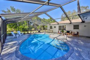 an indoor swimming pool with a glass roof at Lazy Manatee Pool Home in Bradenton