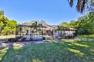 an exterior view of a house with a swimming pool at Lazy Manatee Pool Home in Bradenton
