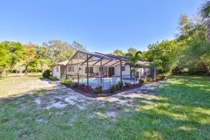 a house with a swimming pool in a yard at Lazy Manatee Pool Home in Bradenton