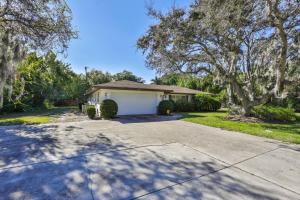 a house with a white garage in a yard at Lazy Manatee Pool Home in Bradenton